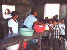 Children stand in line for food in Nicaragua - Click for more information